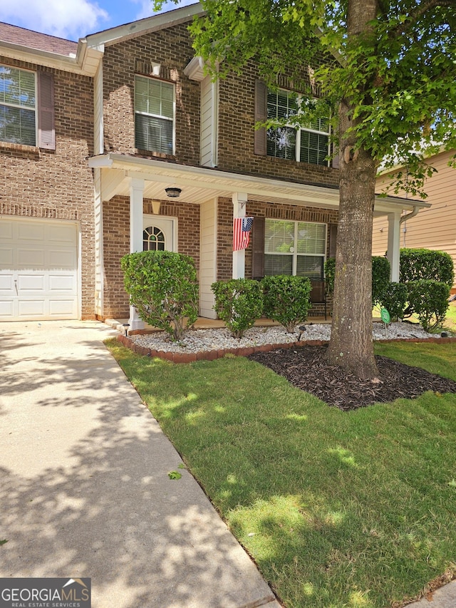 view of front of home featuring a front yard and a garage