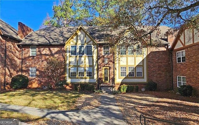 tudor house featuring a front yard