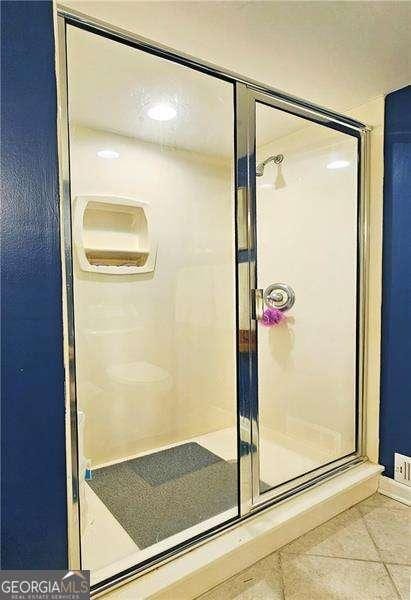 bathroom featuring tile patterned flooring and walk in shower