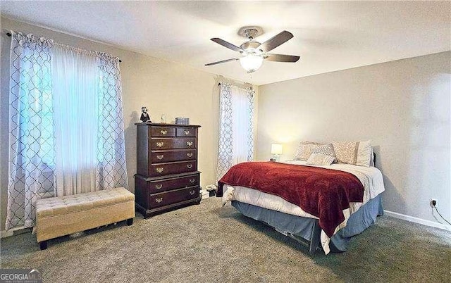 carpeted bedroom with ceiling fan and multiple windows