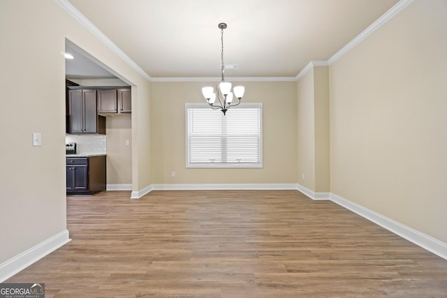 2275 Lovejoy Rd Lot 72, Hampton, GA 30228 - unfurnished dining area featuring a chandelier, crown molding, light wood-type flooring, and baseboards