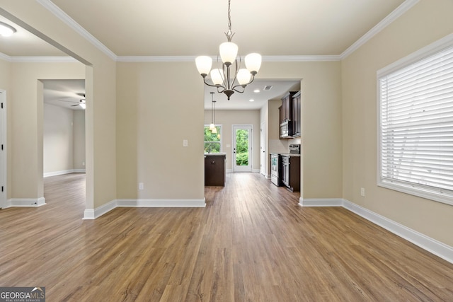 unfurnished living room featuring wood-type flooring, ceiling fan with notable chandelier, and ornamental molding