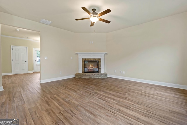 2275 Lovejoy Rd Lot 72, Hampton, GA 30228 - unfurnished living room with ceiling fan, wood finished floors, a fireplace, and baseboards