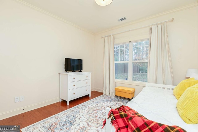 bedroom featuring ornamental molding and wood-type flooring