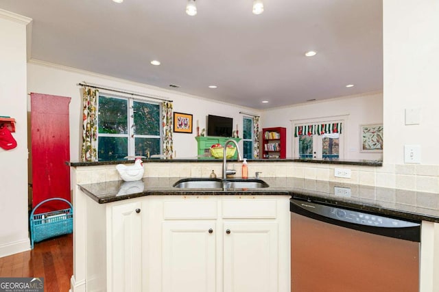 kitchen with stainless steel dishwasher, dark hardwood / wood-style flooring, white cabinets, dark stone countertops, and sink