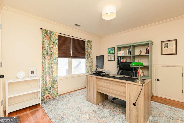 home office featuring hardwood / wood-style floors and crown molding