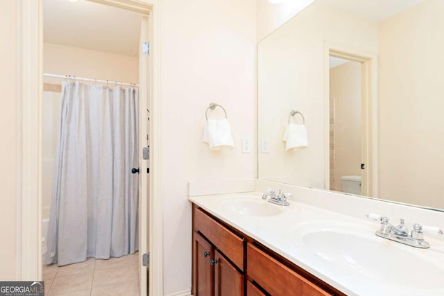 bathroom featuring tile patterned flooring, vanity, and toilet