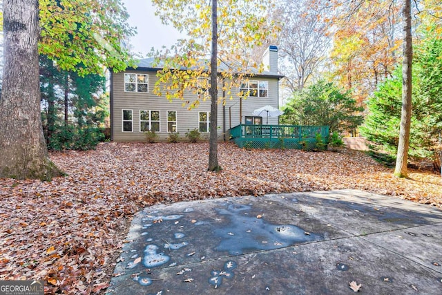 back of property with a patio area and a wooden deck