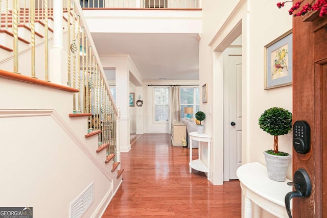 foyer featuring hardwood / wood-style floors and ornamental molding