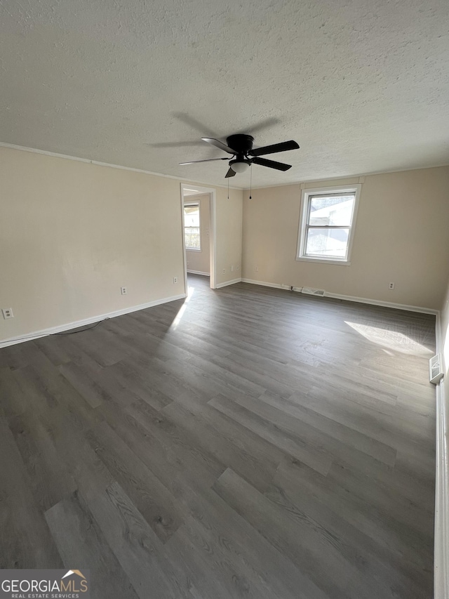 unfurnished room featuring a textured ceiling, dark hardwood / wood-style flooring, and ceiling fan