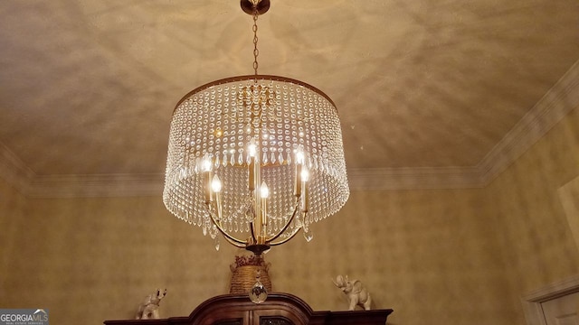 room details featuring ornamental molding and a chandelier