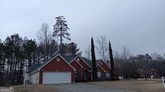 front of property with a garage and central air condition unit