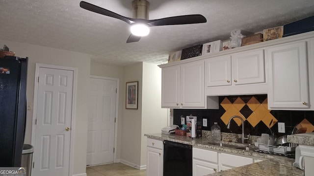 kitchen with sink, black appliances, white cabinets, a textured ceiling, and decorative backsplash