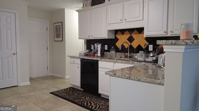 kitchen featuring white cabinetry, sink, and light tile patterned flooring