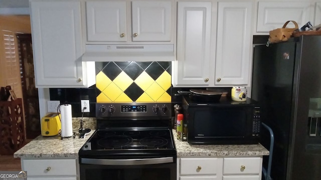 kitchen with tasteful backsplash, light stone countertops, white cabinets, and black appliances