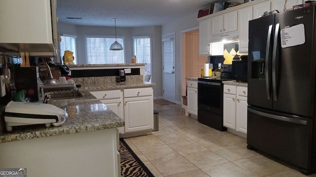 kitchen featuring sink, white cabinetry, decorative light fixtures, light tile patterned floors, and black appliances