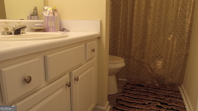 bathroom featuring vanity and toilet