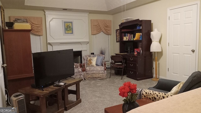 interior space with carpet floors and a large fireplace