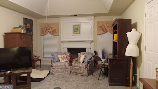 living area featuring vaulted ceiling and carpet