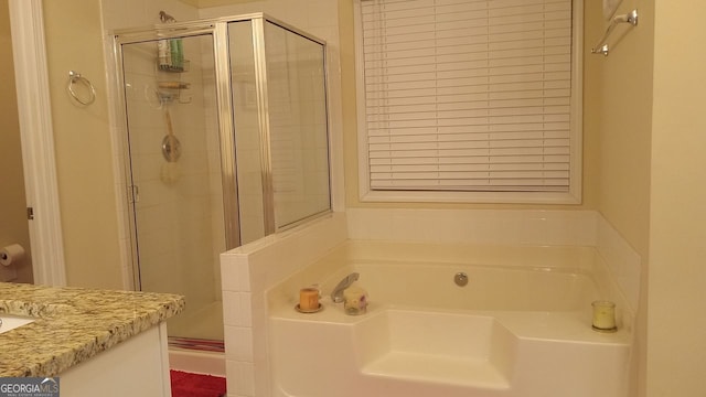 bathroom featuring plus walk in shower and vanity