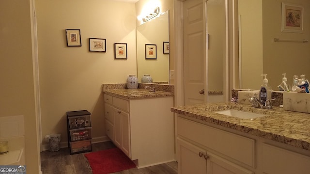 bathroom featuring vanity and hardwood / wood-style flooring