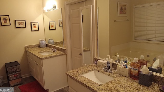 bathroom featuring vanity and a tub