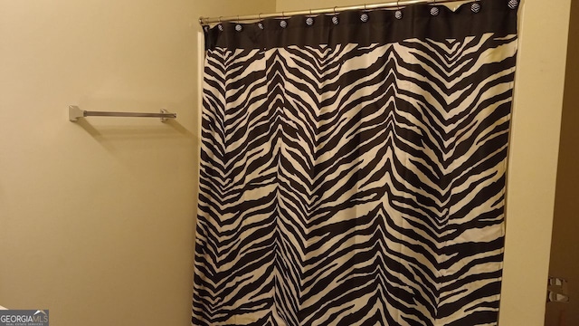 bathroom with a shower with shower curtain