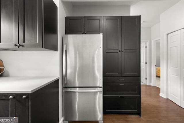 kitchen with stainless steel refrigerator and dark hardwood / wood-style floors