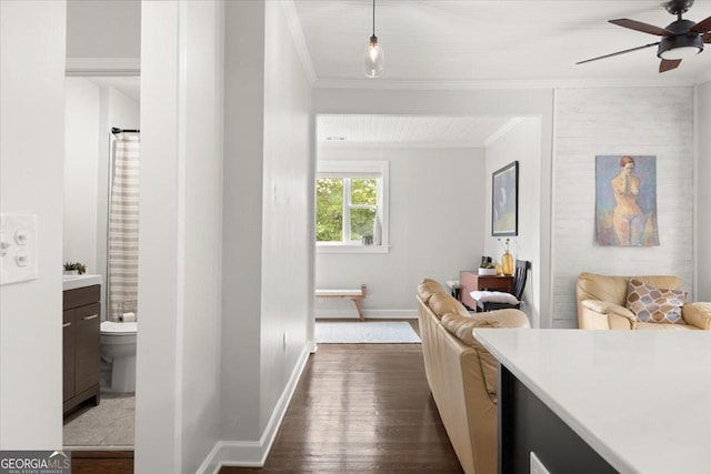 hallway featuring dark hardwood / wood-style flooring and crown molding