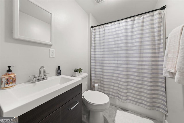 bathroom featuring vanity, a shower with shower curtain, and toilet