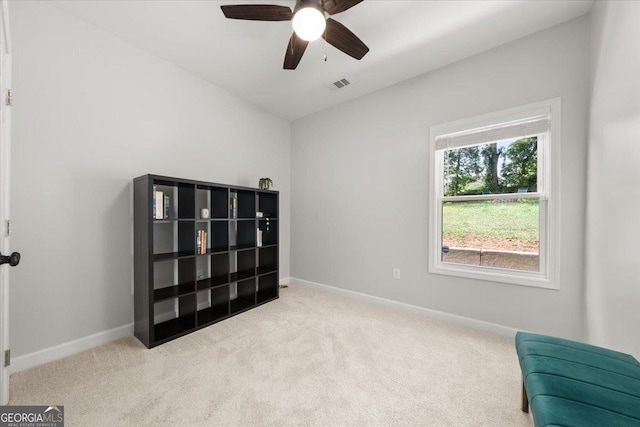 sitting room featuring ceiling fan and light colored carpet