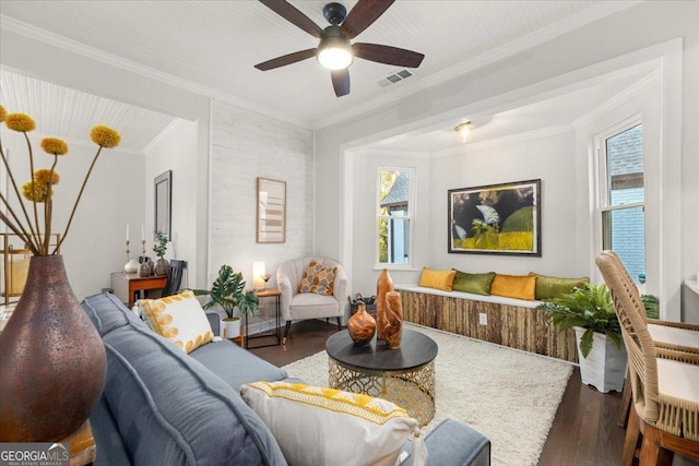 living room with crown molding, dark hardwood / wood-style flooring, and ceiling fan