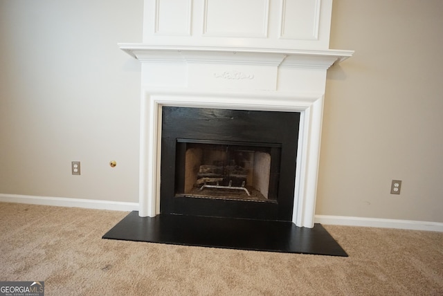 interior details with a fireplace, baseboards, and carpet flooring