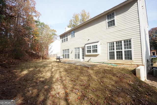 rear view of house featuring central AC unit