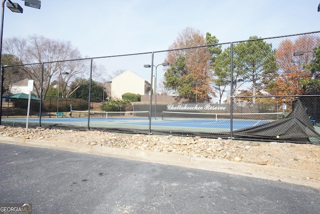 view of sport court featuring fence