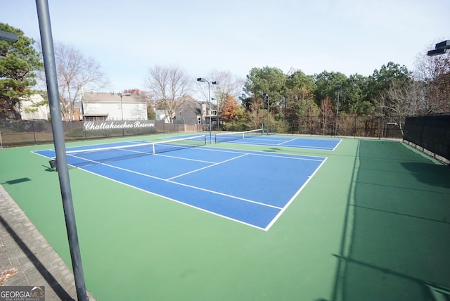 view of sport court featuring fence