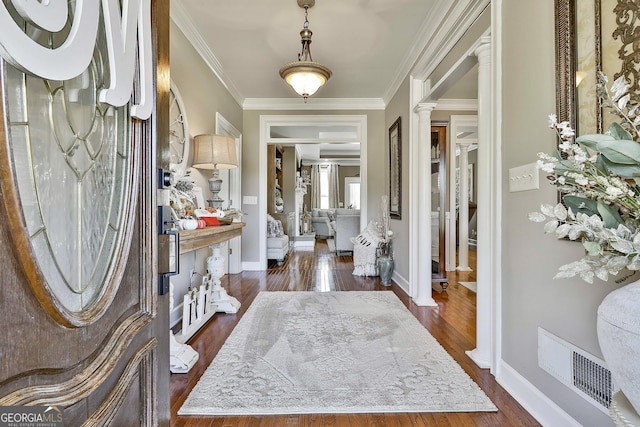 foyer with dark hardwood / wood-style floors and ornamental molding