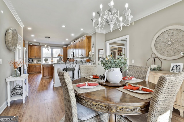 dining area with a notable chandelier, crown molding, and dark wood-type flooring