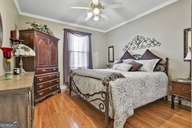 bedroom featuring light wood-type flooring, ceiling fan, and ornamental molding