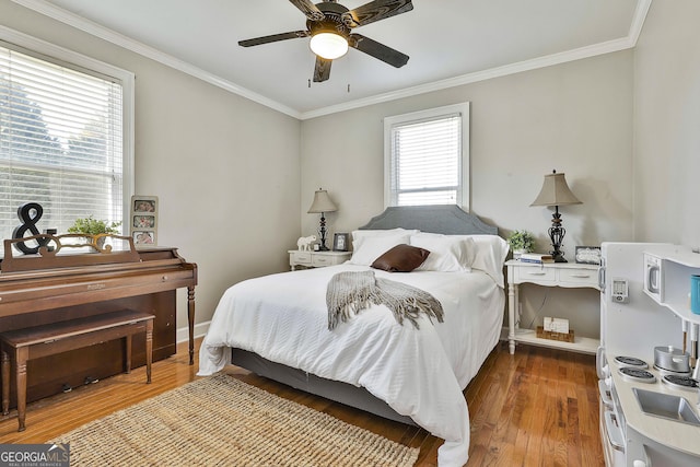 bedroom with wood-type flooring, multiple windows, ornamental molding, and ceiling fan