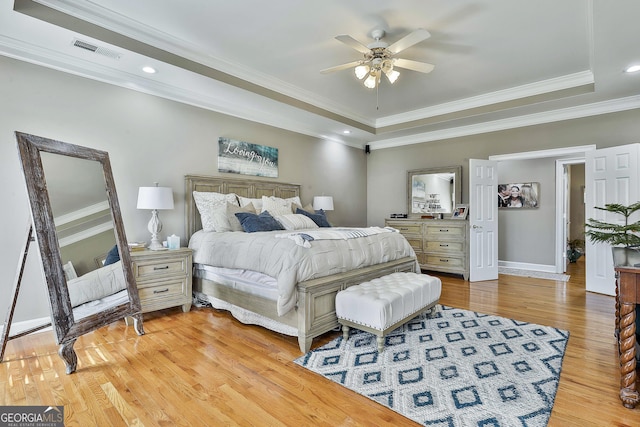 bedroom with ceiling fan, light hardwood / wood-style floors, and ornamental molding