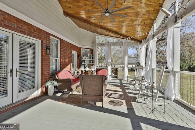 sunroom featuring french doors, ceiling fan, and wooden ceiling