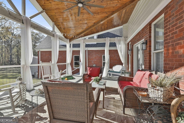 sunroom with ceiling fan, lofted ceiling, and wood ceiling