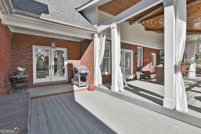 wooden terrace featuring area for grilling and french doors