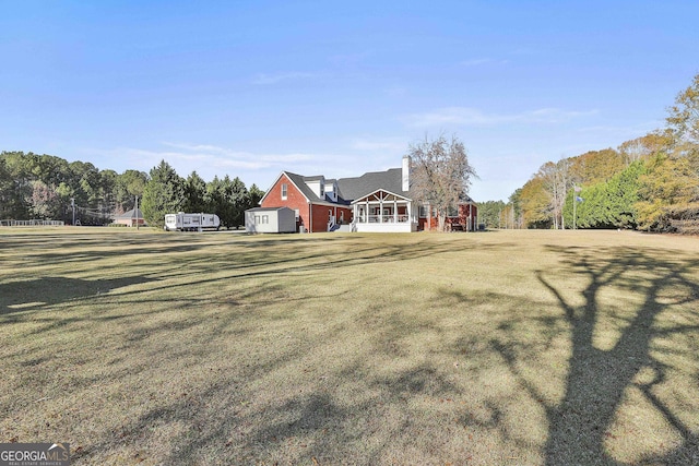 view of front facade featuring a sunroom and a front lawn