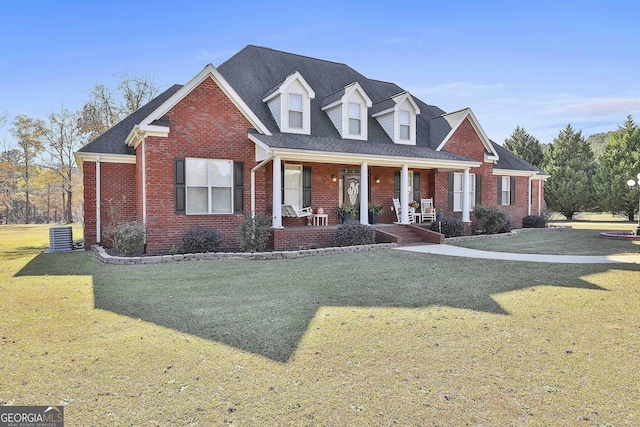 cape cod home featuring cooling unit, covered porch, and a front lawn