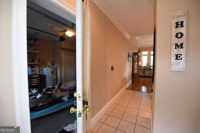 corridor featuring light tile patterned flooring, electric water heater, and ornamental molding