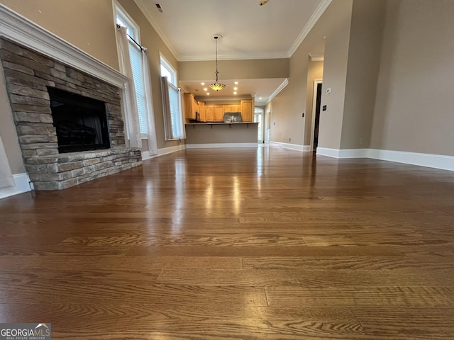 unfurnished living room featuring hardwood / wood-style floors, a fireplace, and ornamental molding