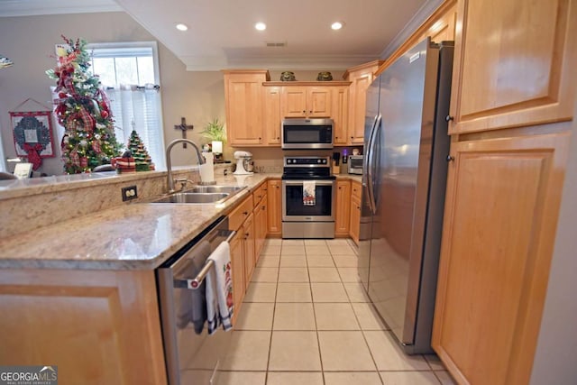 kitchen with sink, light stone counters, appliances with stainless steel finishes, light tile patterned floors, and ornamental molding