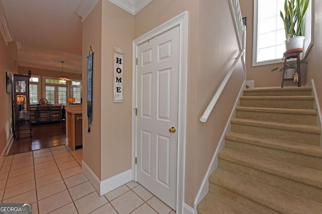 staircase with tile patterned flooring and ornamental molding